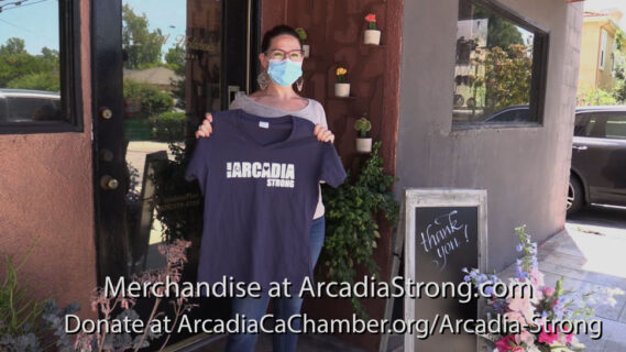 Aleah Holakoui in front of Holakoui florist holding an Arcadia Strong t-shirt