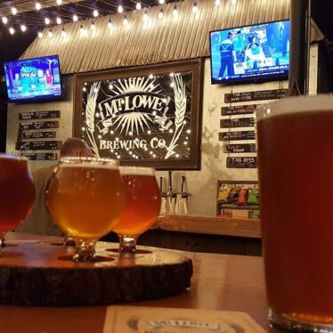 Mt. Lowe Brewing with beer glasses on their bar and Televisions in the background